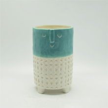 Vase en céramique à quatre jambes d'expression de dessin animé de caractère vert et blanc