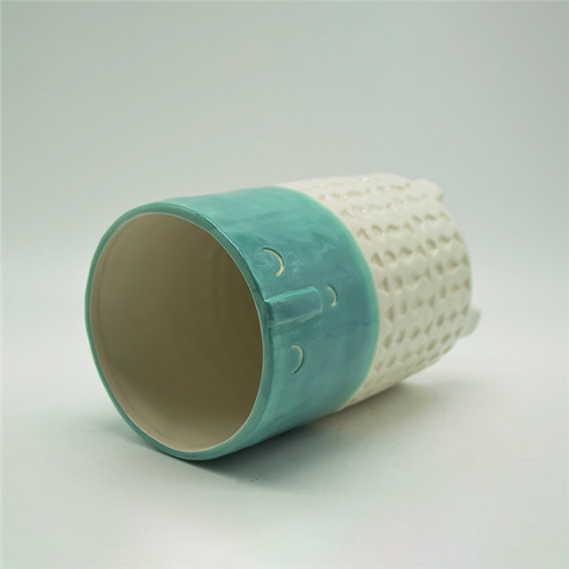 Vase en céramique à quatre jambes d'expression de dessin animé de caractère vert et blanc